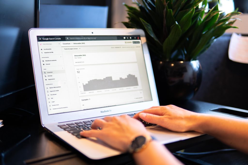 A person reading tips for building a successful SEO strategy in 2022 on their laptop.